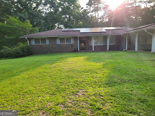 4157 Cedar Valley Ln, Conley, GA 30288 - single story home featuring roof mounted solar panels, a porch, a front lawn, and brick siding