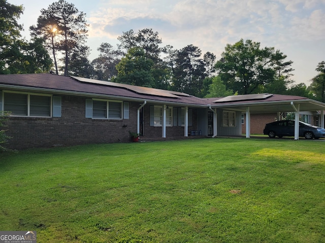 4157 Cedar Valley Ln, Conley, GA 30288 - ranch-style home with covered porch, a front yard, roof mounted solar panels, and an attached carport