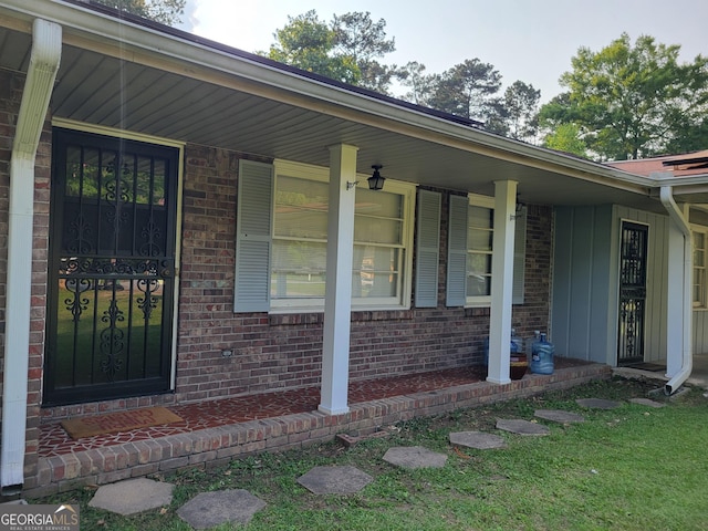 4157 Cedar Valley Ln, Conley, GA 30288 - entrance to property featuring a porch, brick siding, and board and batten siding