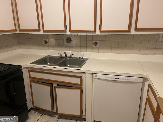 1308 Camelot Dr, South Fulton, GA 30349 - kitchen featuring white dishwasher, light countertops, black / electric stove, and decorative backsplash