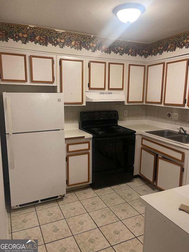 1308 Camelot Dr, South Fulton, GA 30349 - kitchen featuring freestanding refrigerator, electric range, under cabinet range hood, light countertops, and backsplash