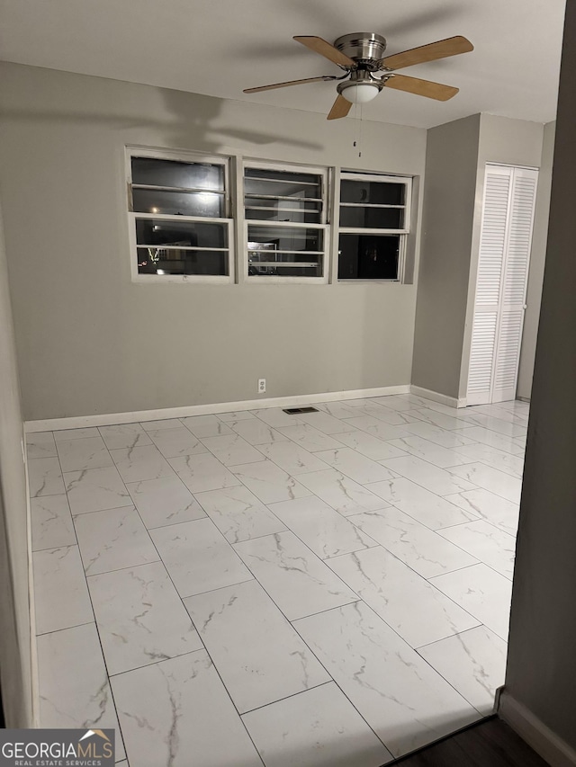 225 Bell St, Covington, GA 30016 - spare room featuring baseboards, ceiling fan, and marble finish flooring