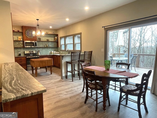 400 Mulberry Cir, Jasper, GA 30143 - dining room featuring healthy amount of natural light, light wood-style floors, a chandelier, and recessed lighting