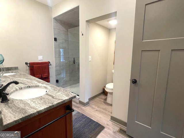 400 Mulberry Cir, Jasper, GA 30143 - bathroom with a stall shower, double vanity, and wood finished floors
