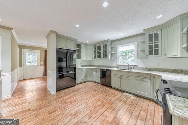 405 W Leslie Ct, Woodstock, GA 30188 - kitchen featuring open shelves, black appliances, green cabinetry, ornamental molding, and a wainscoted wall