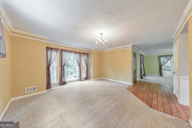 405 W Leslie Ct, Woodstock, GA 30188 - carpeted empty room featuring a chandelier, ornamental molding, and a textured ceiling