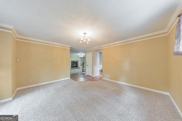 405 W Leslie Ct, Woodstock, GA 30188 - carpeted empty room with a chandelier, crown molding, a textured ceiling, and a glass covered fireplace