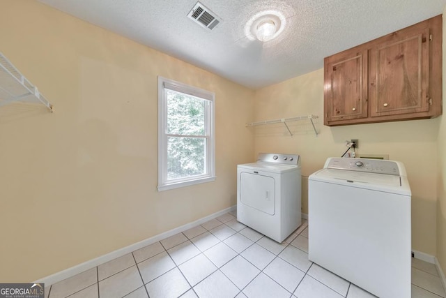 405 W Leslie Ct, Woodstock, GA 30188 - laundry room featuring washer and dryer, cabinet space, a textured ceiling, and light tile patterned floors