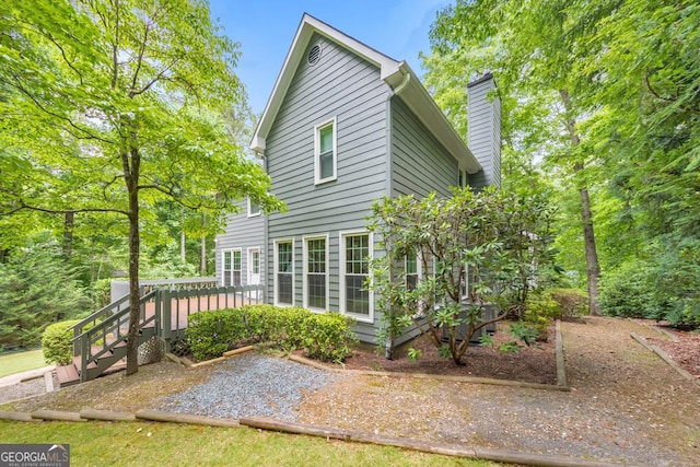 405 W Leslie Ct, Woodstock, GA 30188 - back of property with a wooden deck and a chimney
