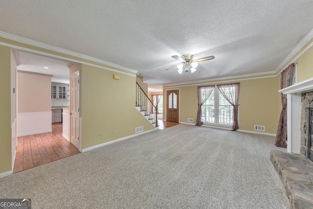 405 W Leslie Ct, Woodstock, GA 30188 - unfurnished living room with stairway, carpet flooring, ceiling fan, a textured ceiling, and a fireplace