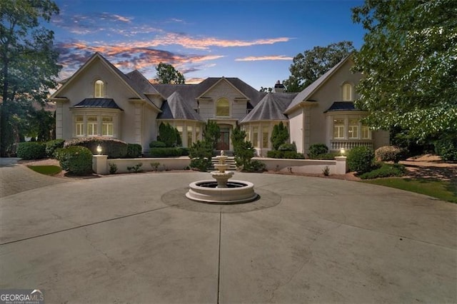 9005 Old Southwick Pass, Alpharetta, GA 30022 - french country style house with stucco siding, a standing seam roof, and a chimney