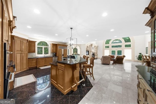 9005 Old Southwick Pass, Alpharetta, GA 30022 - kitchen featuring open floor plan, a breakfast bar area, brown cabinets, recessed lighting, and dark countertops