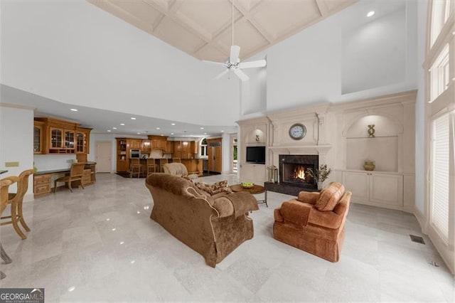 9005 Old Southwick Pass, Alpharetta, GA 30022 - living room featuring a high ceiling, a premium fireplace, coffered ceiling, a ceiling fan, and recessed lighting