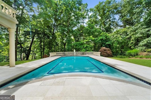 9005 Old Southwick Pass, Alpharetta, GA 30022 - swimming pool featuring a patio area and view of wooded area