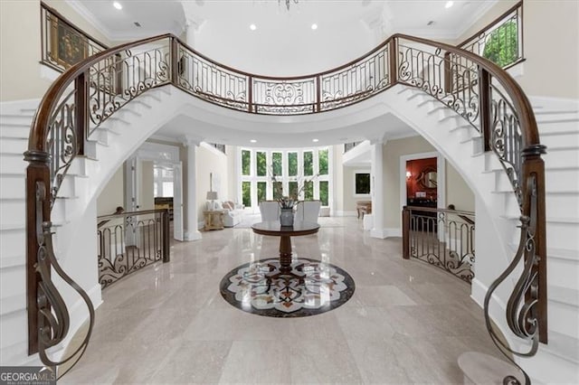 9005 Old Southwick Pass, Alpharetta, GA 30022 - entrance foyer featuring ornamental molding, stairs, a towering ceiling, arched walkways, and recessed lighting
