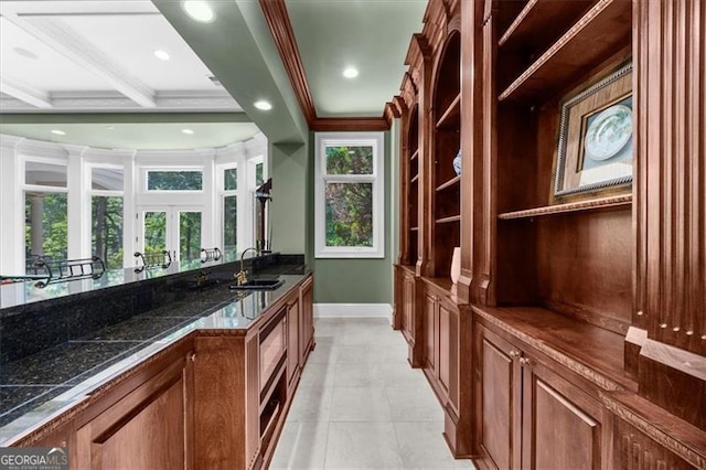 9005 Old Southwick Pass, Alpharetta, GA 30022 - kitchen featuring ornamental molding, dark countertops, brown cabinetry, open shelves, and light tile patterned floors