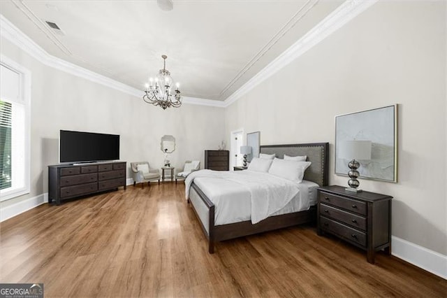 9005 Old Southwick Pass, Alpharetta, GA 30022 - bedroom with wood finished floors, a chandelier, and crown molding