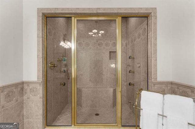 9005 Old Southwick Pass, Alpharetta, GA 30022 - full bath featuring a shower stall, tile walls, and wainscoting