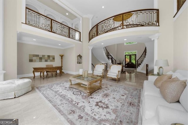 9005 Old Southwick Pass, Alpharetta, GA 30022 - living room featuring decorative columns, a high ceiling, stairway, ornamental molding, and recessed lighting