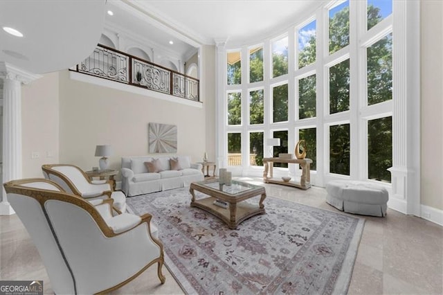 9005 Old Southwick Pass, Alpharetta, GA 30022 - living room with ornate columns, a high ceiling, crown molding, and recessed lighting