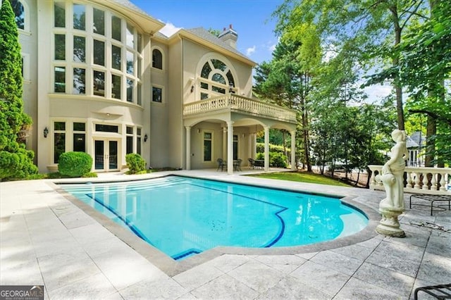 9005 Old Southwick Pass, Alpharetta, GA 30022 - swimming pool with french doors and a patio area