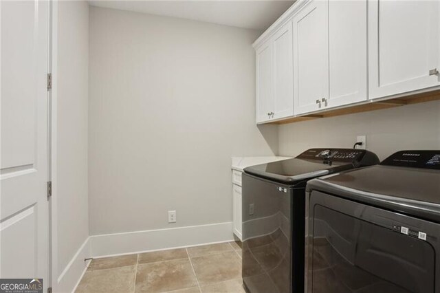 3332 Old Concord Rd SE, Smyrna, GA 30082 - laundry room with washer and dryer, cabinet space, and light tile patterned floors