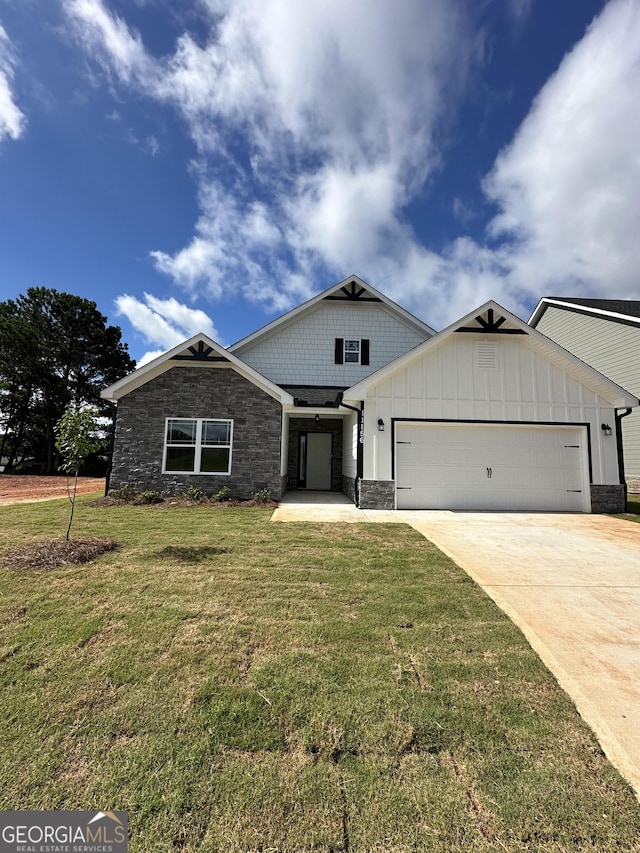 11156 Cornerstone Way, Hampton, GA 30228 - craftsman house with stone siding, a garage, a front yard, concrete driveway, and board and batten siding