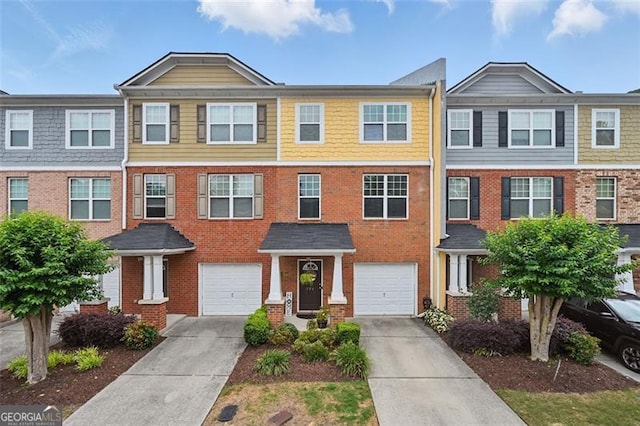 771 Tulip Poplar, Lawrenceville, GA 30044 - view of property with concrete driveway, brick siding, and an attached garage