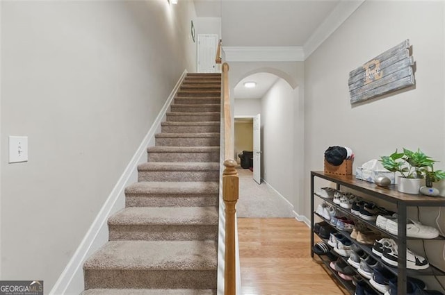771 Tulip Poplar, Lawrenceville, GA 30044 - stairs featuring arched walkways, ornamental molding, and wood finished floors
