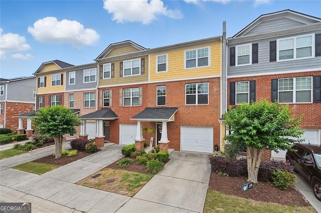 771 Tulip Poplar, Lawrenceville, GA 30044 - view of property featuring an attached garage, driveway, and brick siding
