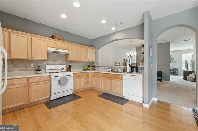 771 Tulip Poplar, Lawrenceville, GA 30044 - kitchen with white appliances, light brown cabinets, under cabinet range hood, arched walkways, and light countertops