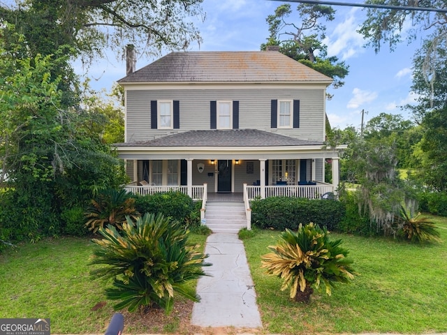 627 E Broughton St, Bainbridge, GA 39817 - view of front of property with a front yard, covered porch, and a chimney