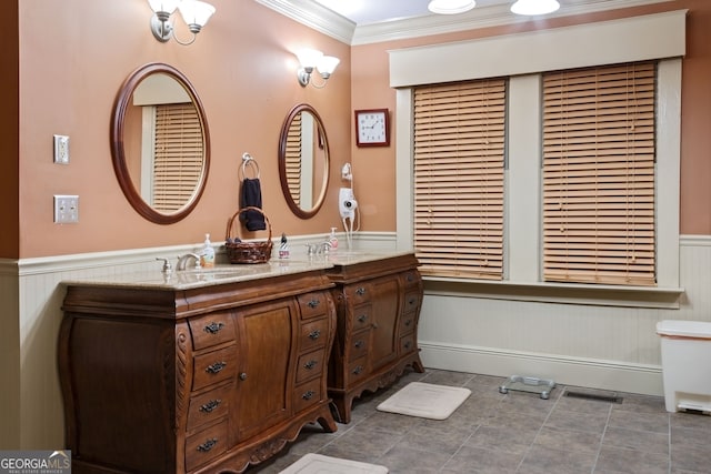 627 E Broughton St, Bainbridge, GA 39817 - full bathroom with double vanity, wainscoting, ornamental molding, and tile patterned floors