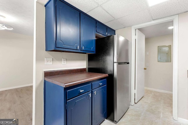 3184 Nectarine Cir, Decatur, GA 30034 - kitchen featuring blue cabinetry, freestanding refrigerator, electric panel, and dark countertops