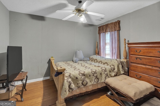 4969 Truitt Ln, Decatur, GA 30035 - bedroom with wood finished floors, a textured ceiling, and ceiling fan