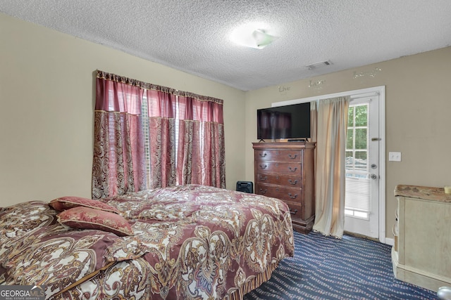 4969 Truitt Ln, Decatur, GA 30035 - carpeted bedroom with a textured ceiling and access to exterior