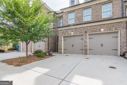5535 Bright Cross Way, Suwanee, GA 30024 - view of front facade featuring brick siding, concrete driveway, and an attached garage