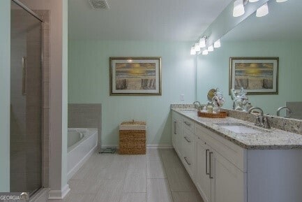 5535 Bright Cross Way, Suwanee, GA 30024 - full bathroom featuring double vanity, a garden tub, and tiled shower