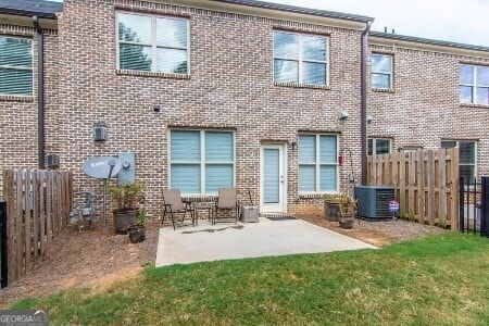5535 Bright Cross Way, Suwanee, GA 30024 - rear view of property with a fenced backyard, a patio area, and brick siding