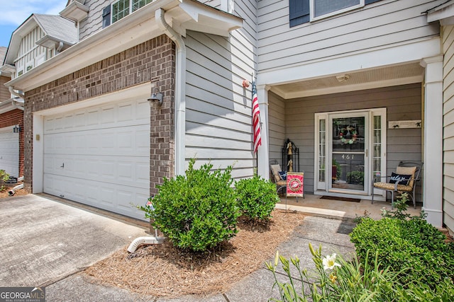 461 Mountain View Ln, Woodstock, GA 30188 - view of exterior entry with a garage, concrete driveway, and brick siding