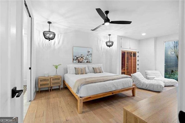 130 Marina Parc Dr, Waleska, GA 30183 - bedroom featuring light wood-type flooring, a chandelier, and ceiling fan