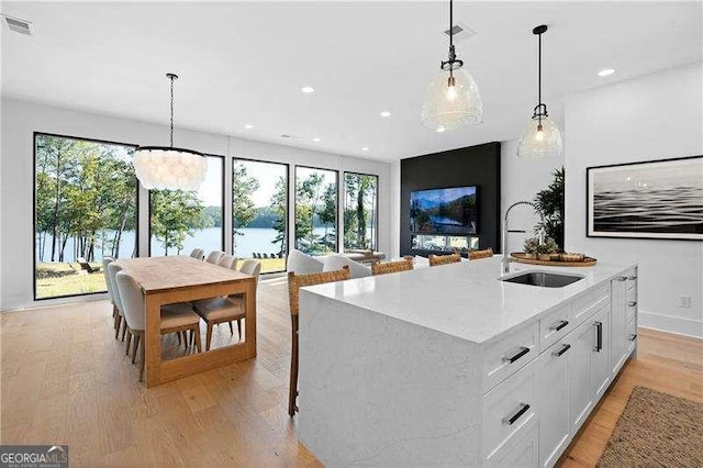 130 Marina Parc Dr, Waleska, GA 30183 - kitchen with a sink, light wood-style flooring, white cabinetry, hanging light fixtures, and recessed lighting