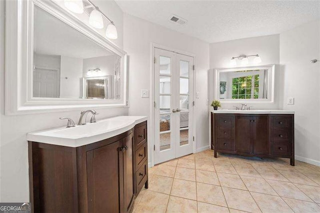 150 Kensley Way, Dallas, GA 30157 - bathroom with french doors, two vanities, tile patterned floors, and baseboards