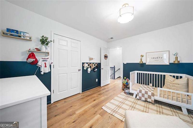 150 Kensley Way, Dallas, GA 30157 - bedroom featuring light wood-type flooring and a nursery area