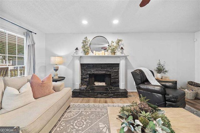 150 Kensley Way, Dallas, GA 30157 - living room featuring wood finished floors, a textured ceiling, a fireplace, ceiling fan, and recessed lighting