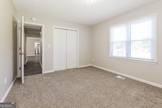 11102 Hunters Ln, Hampton, GA 30228 - unfurnished bedroom with carpet, a closet, and baseboards