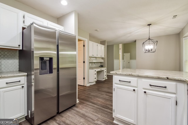 100 Inland Cir, Newnan, GA 30263 - kitchen with stainless steel fridge, white cabinetry, dark wood-style floors, backsplash, and a chandelier