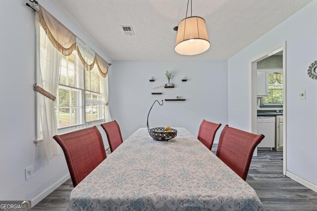1738 Sherry Ln, Jonesboro, GA 30236 - dining room featuring dark wood-style flooring and a textured ceiling