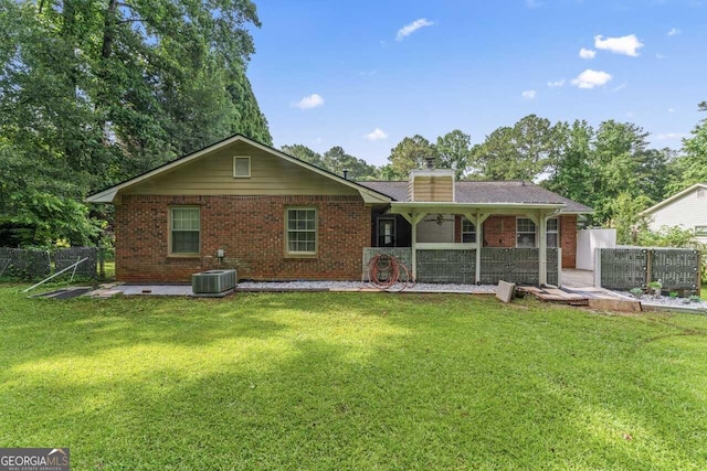 1738 Sherry Ln, Jonesboro, GA 30236 - back of property featuring ceiling fan and brick siding