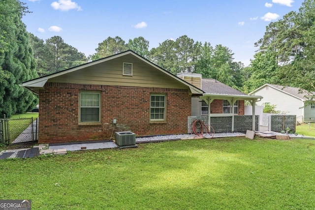 1738 Sherry Ln, Jonesboro, GA 30236 - rear view of house with brick siding, a chimney, and a gate